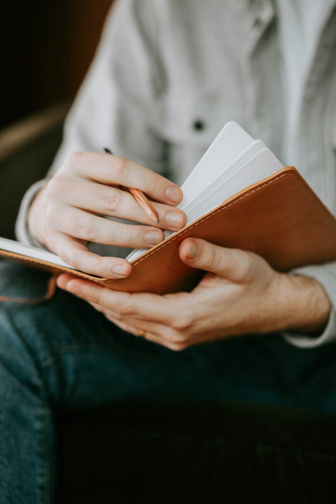 person writing in journal